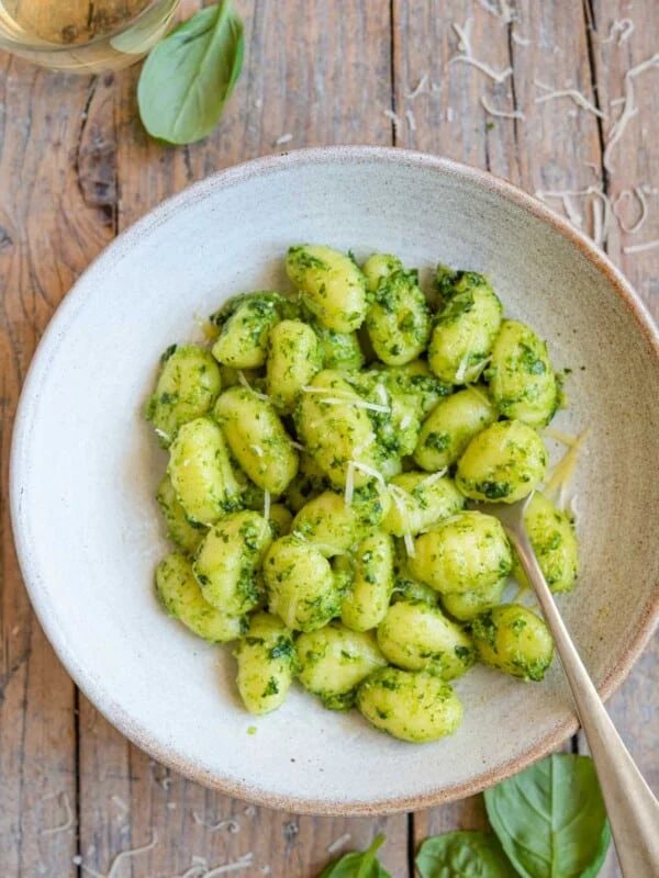 An overhead shot of pesto gnocchi in a bowl