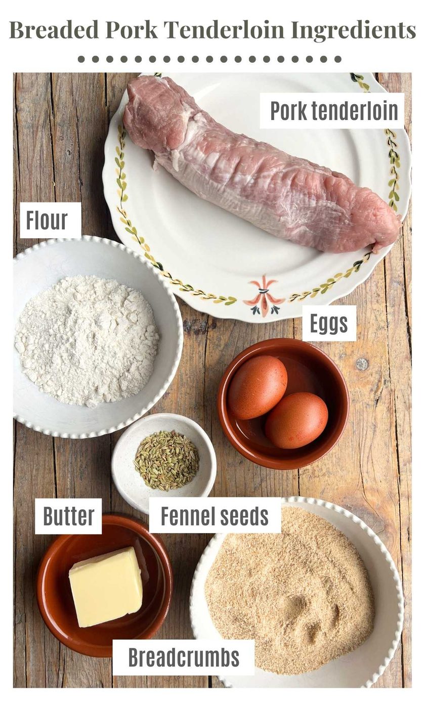 An overhead shot of all the ingredients needed to make breaded pork tenderloin sitting on a wooden surface.