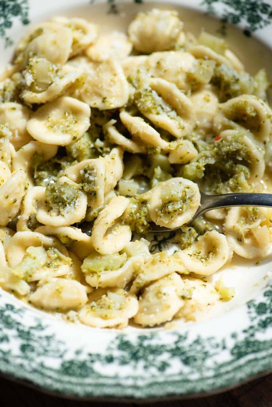 A close up of orecchiette in a bowl with broccoli.
