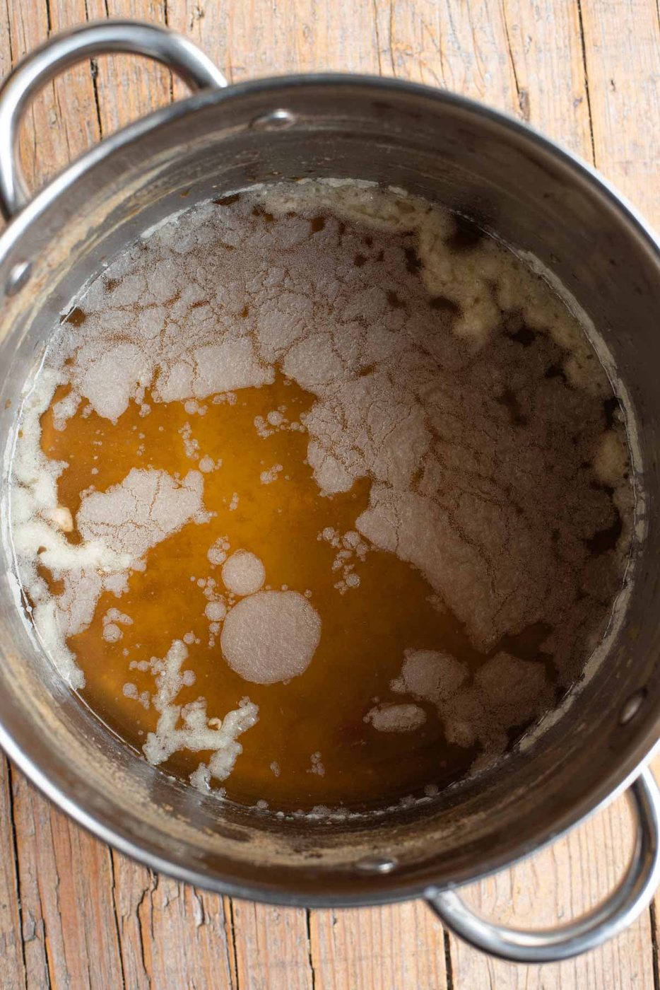 A photo of showing a layer of fat on some Italian meat broth.