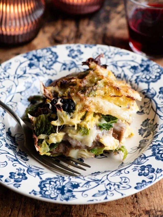 A slice of a rustic Italian casserole on a blue plate.