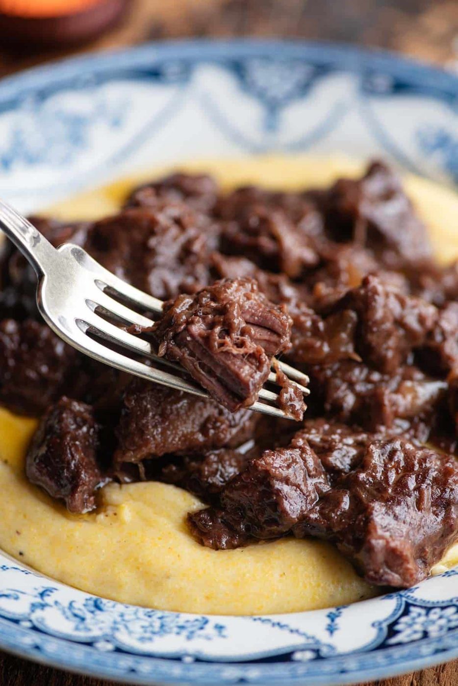 A close up of Italian beef stew on a fork.