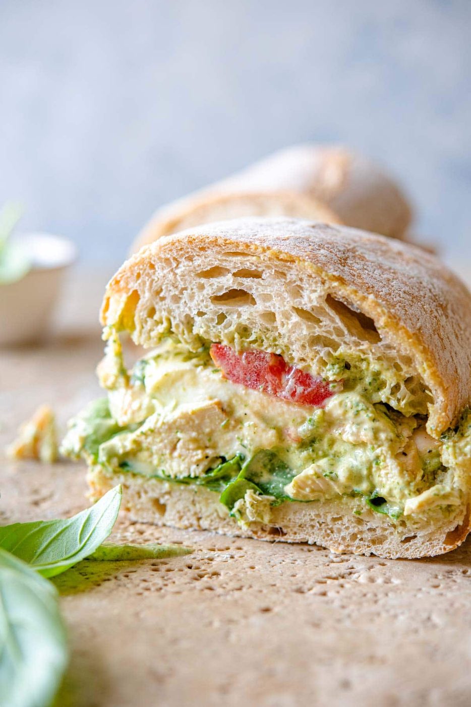 A close up of a chicken pesto ciabatta cut in half