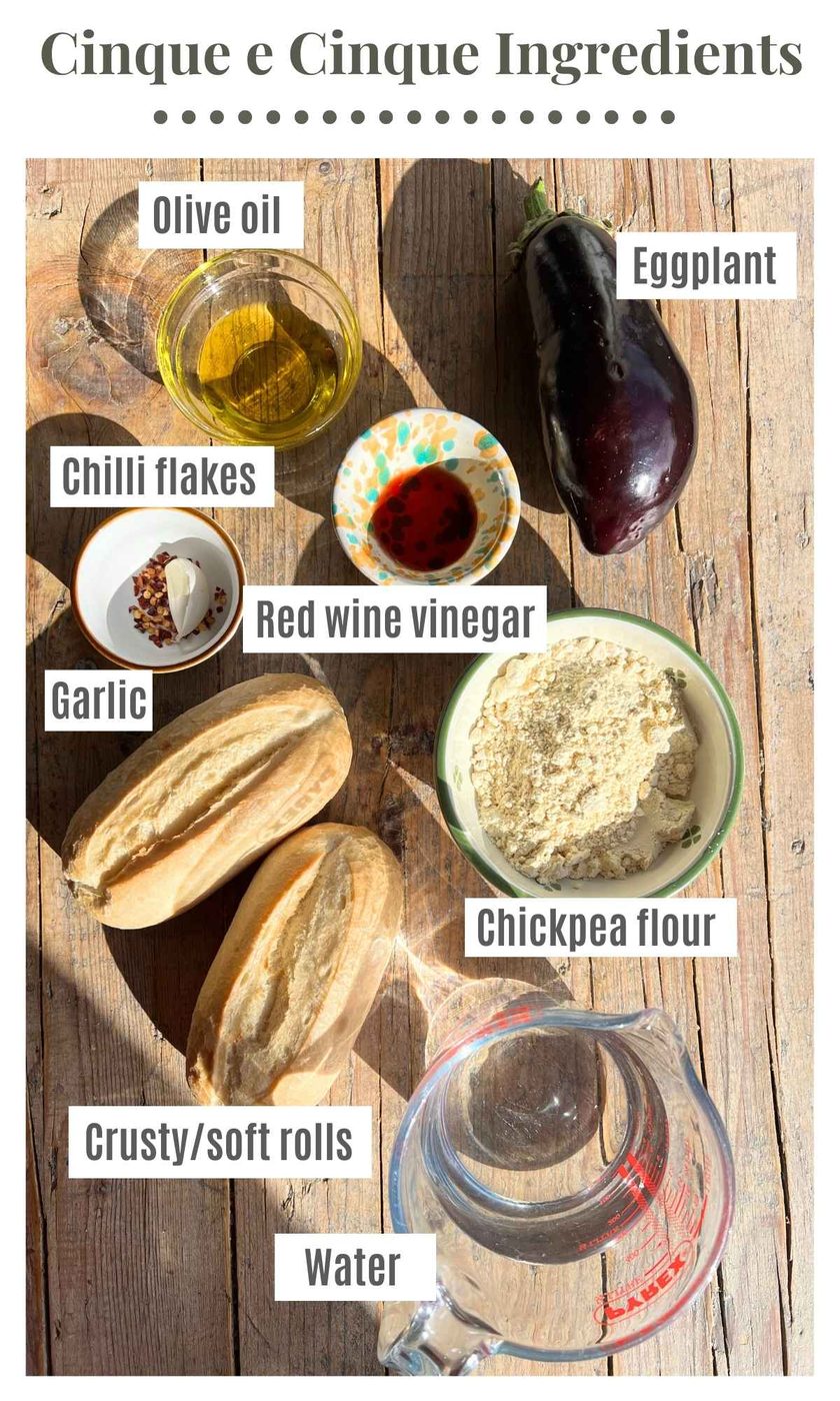 All the ingredients needed to make a 5x5 Livornese sandwich sitting on a rustic wooden background.