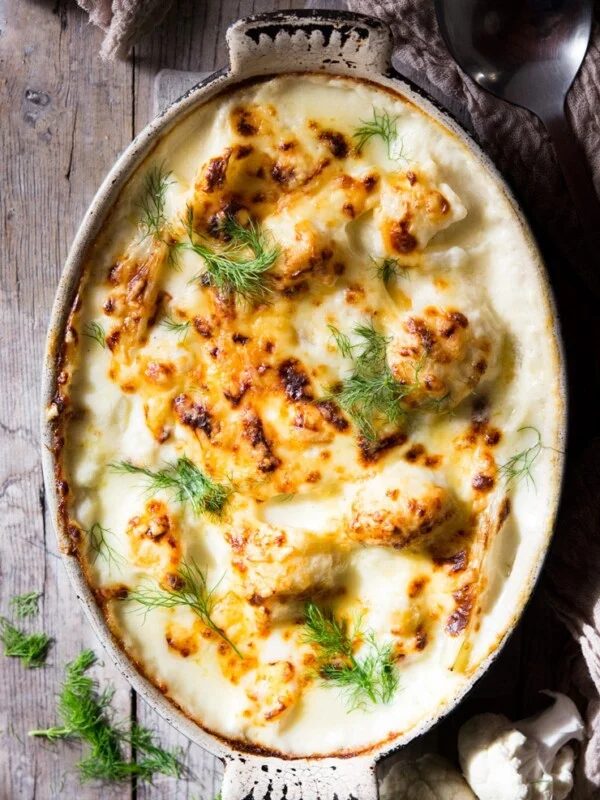 baked cauliflower cheese in a oval baking dish