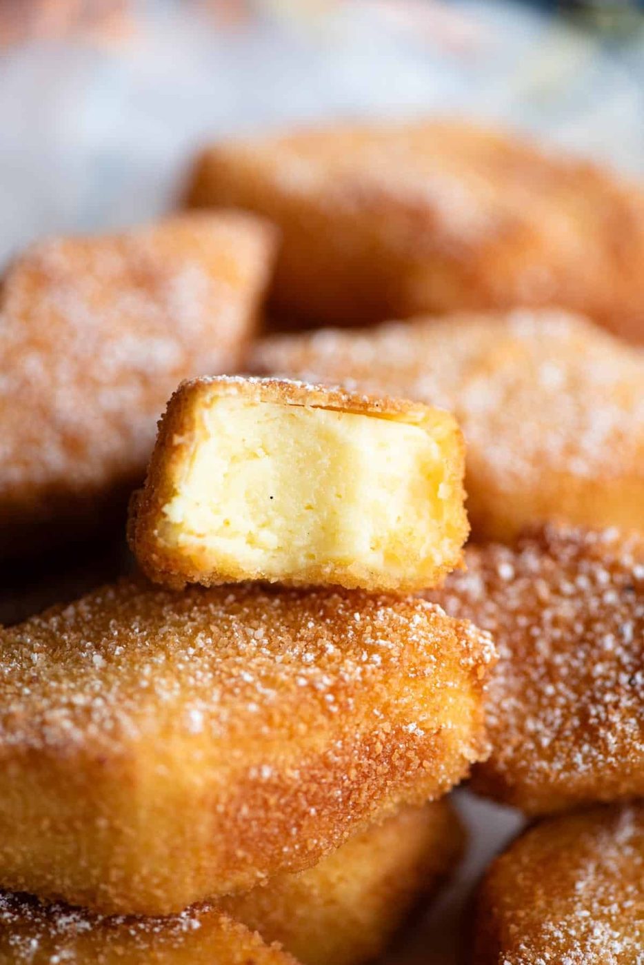 A close up of Crema Fritta, Deep Fried Custard cut in half showing the inside.