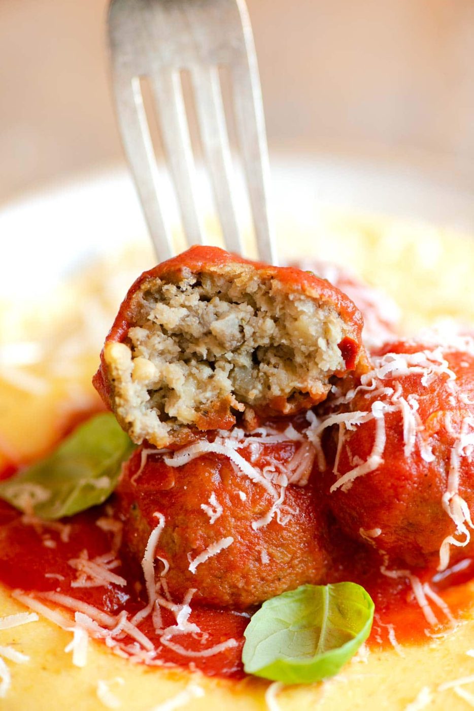 A close up of an eggplant meatball cut in half