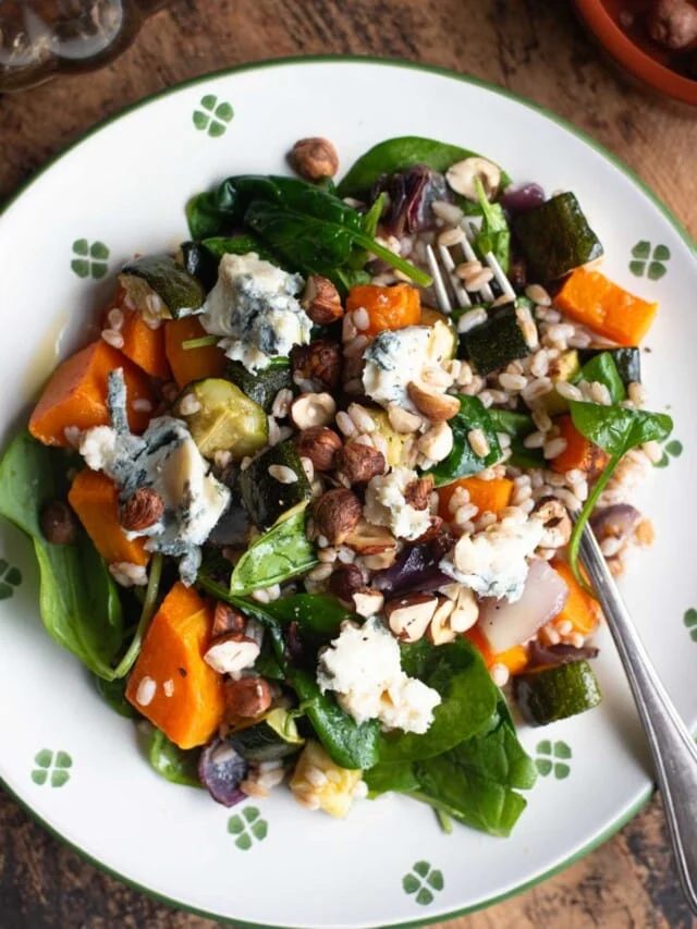 An overhead shot of a warm farro salad with butternut squash, spinach and gorgonzola.