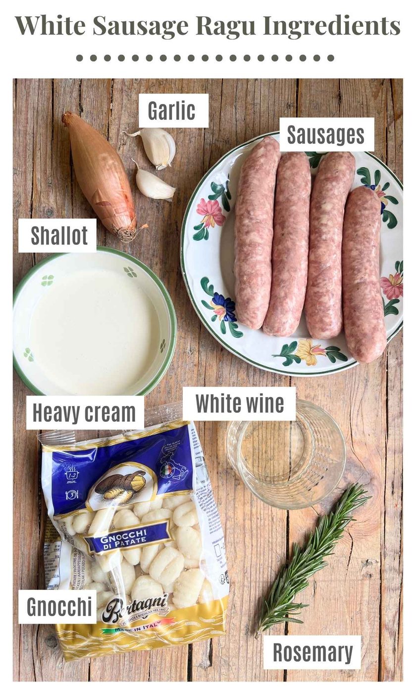 An overhead shot of all the ingredients needed to make gnocchi with a creamy white sausage ragu sitting on a wooden surface.