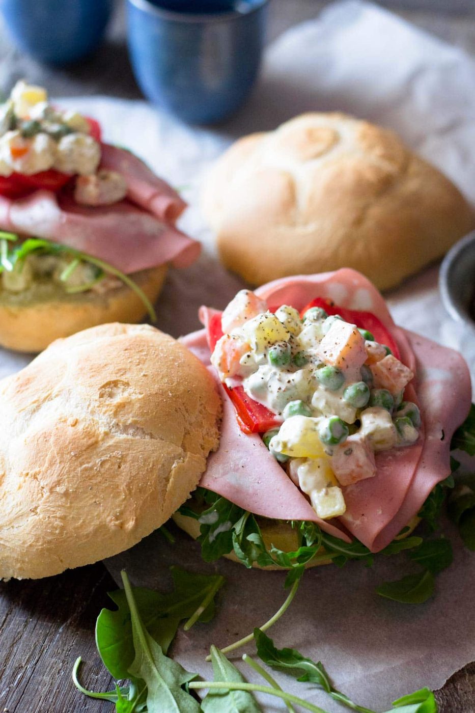 A close up of Russian salad on a bread roll