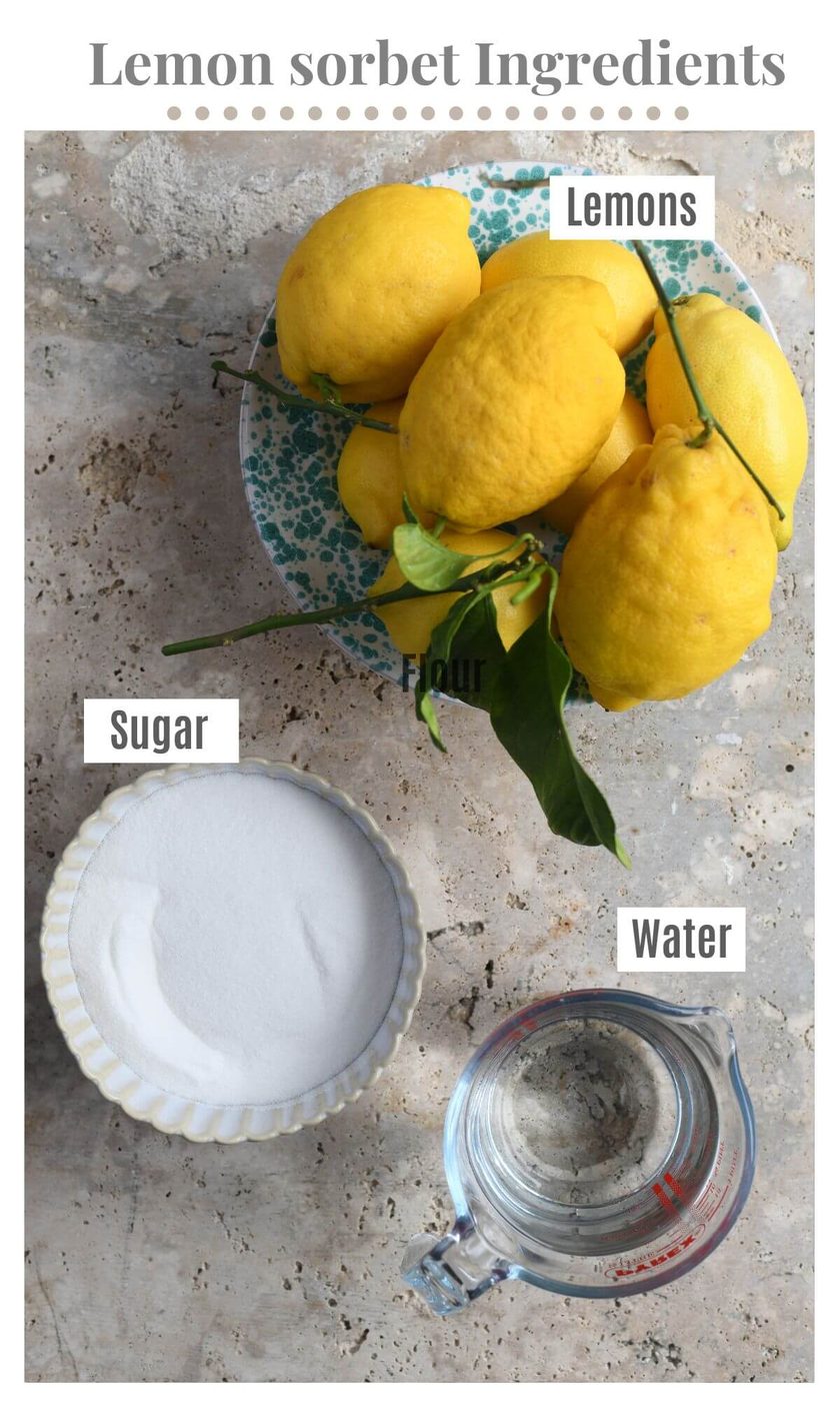 An overhead shot of all the ingredients needed to make lemon sorbet; lemons, sugar and water.