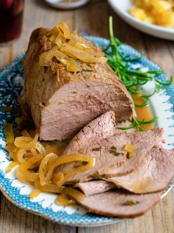 Italian roast beef on a blue serving platter