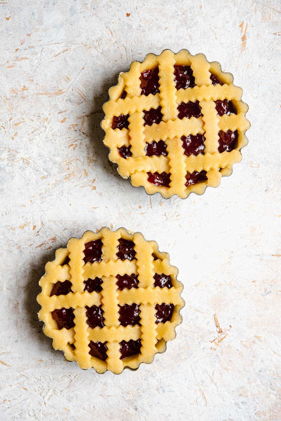 An overhead shot of two shortcrust pastry tarts before being cooked