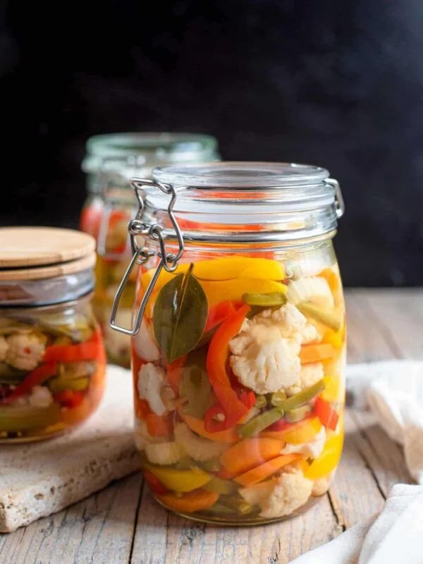 A close up of a jar of pickled vegetables