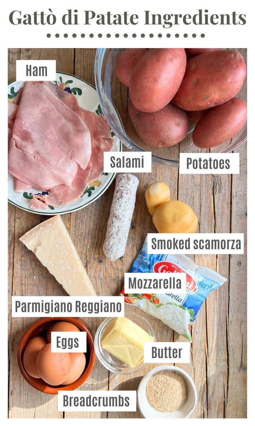 An overhead shot of all the ingredients needed to make Neapolitan Gatto di patate on a rustic wooden surface.