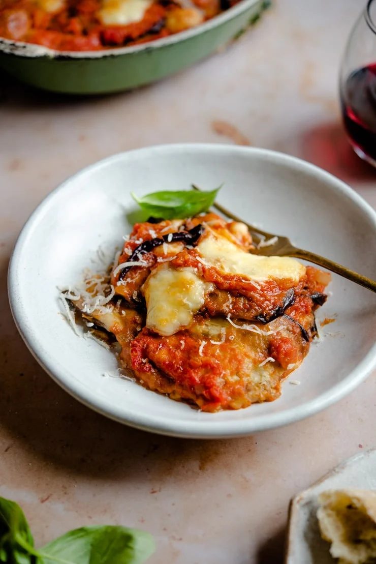 Eggplant parmigiana in a bowl with a fork
