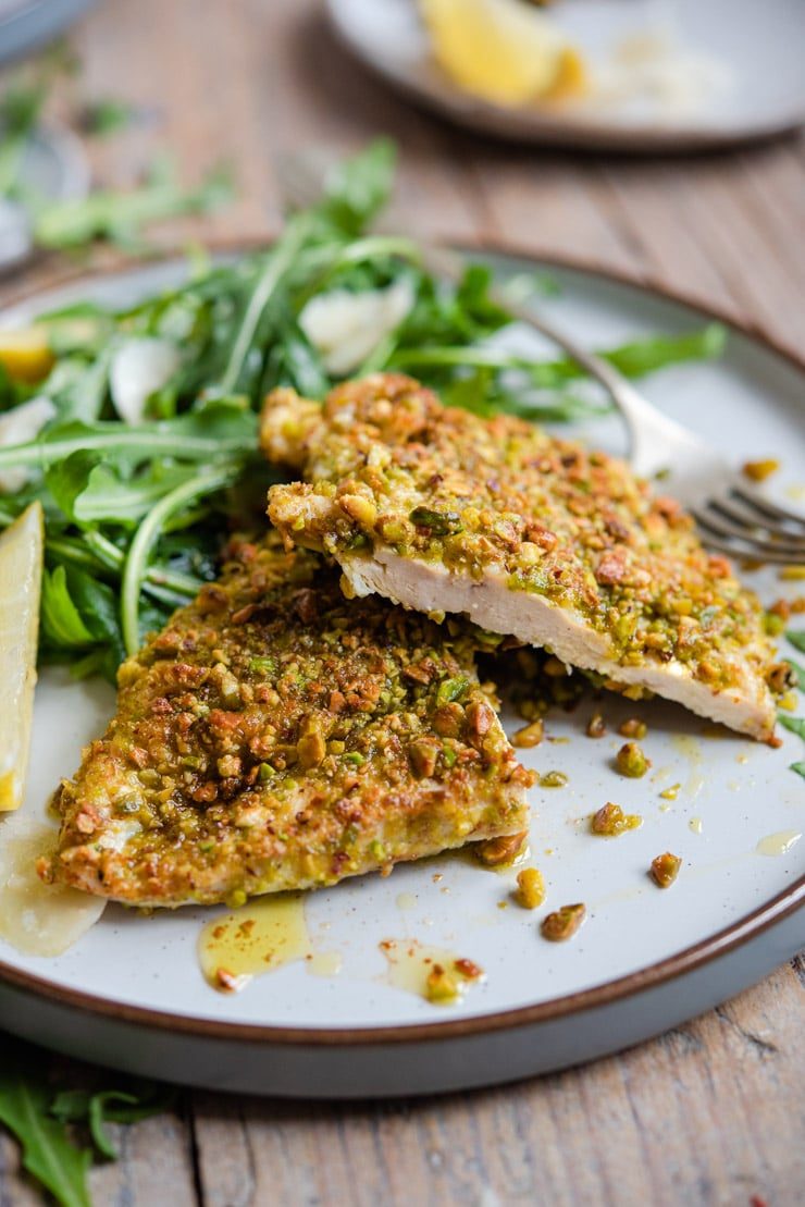 A close up of pistachio crusted chicken cut in half