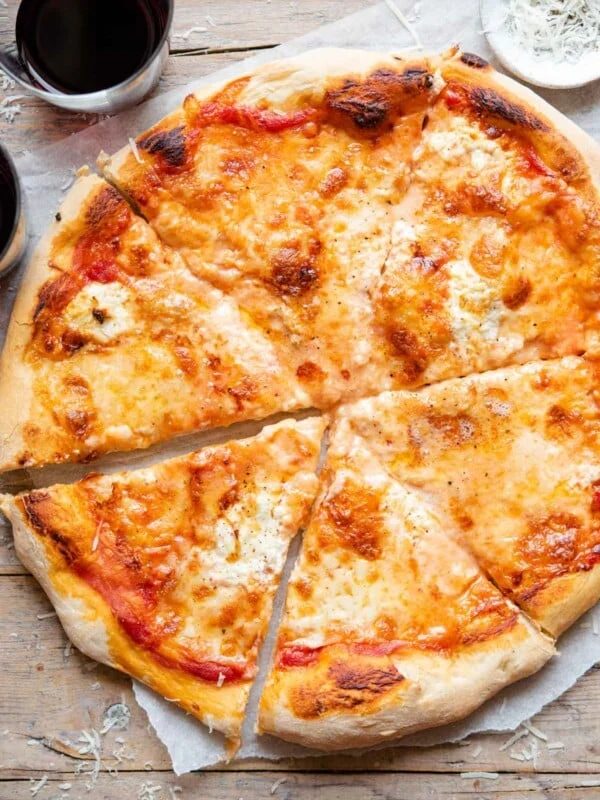 An overhead shot of a four cheese pizza cut into slices
