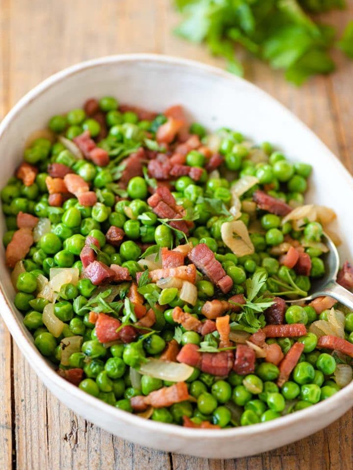 Peas and pancetta in a large serving bowl