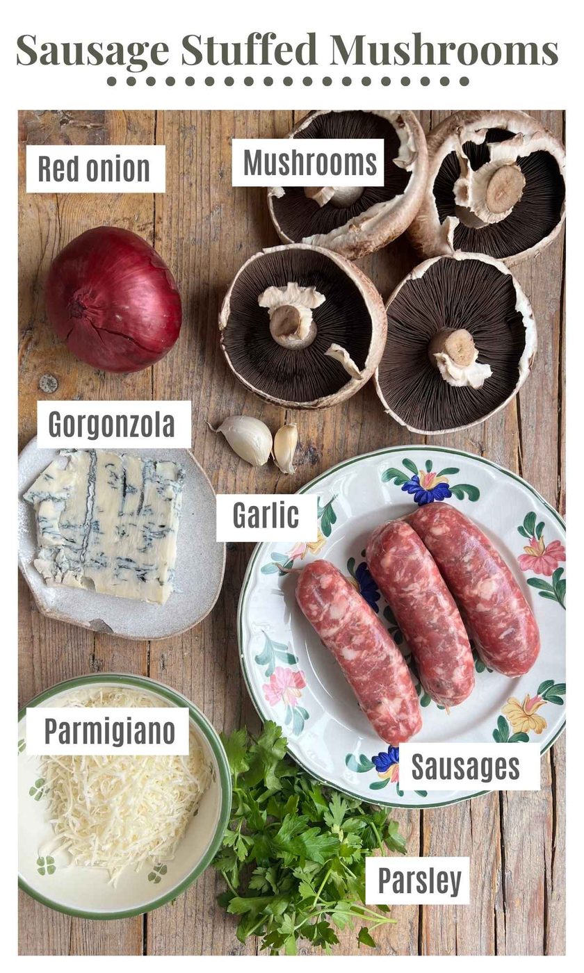An overhead shot of all the ingredients needed to make mushrooms stuffed with sausage and gorgonzola on a wooden surface.
