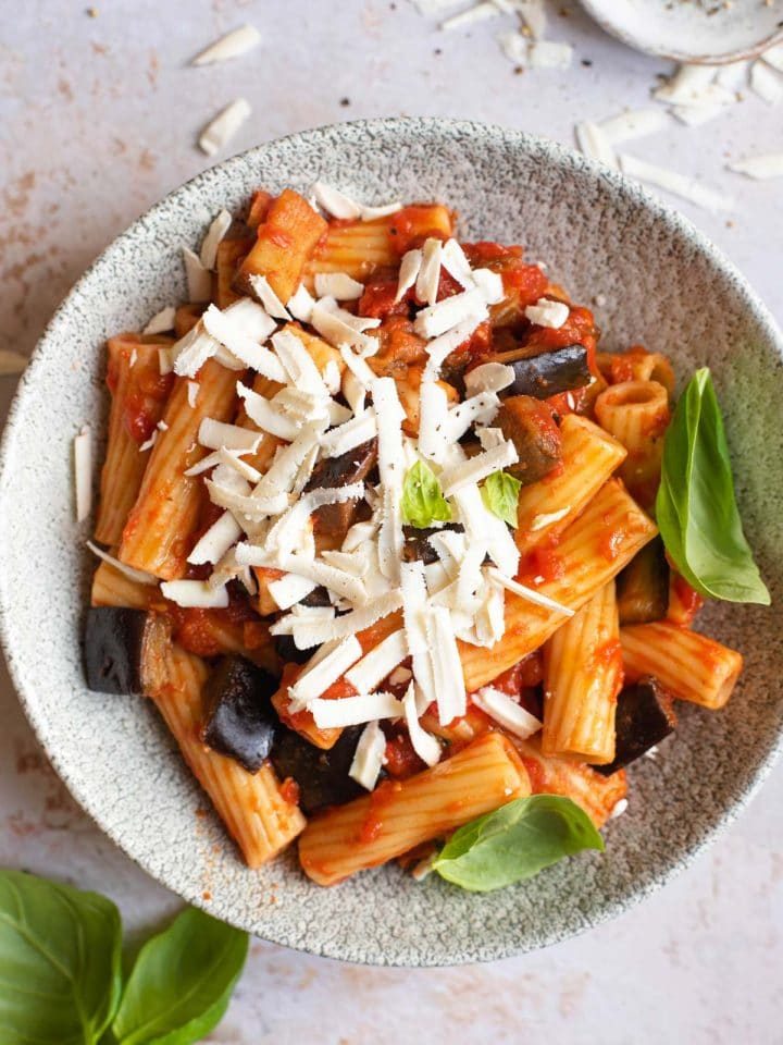 An overhead shot of Pasta alla Norma in a bowl topped with cheese