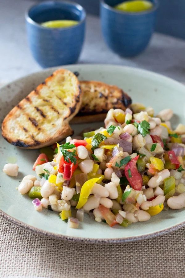 Warm easy bean salad with eggplant, tomato, garlic and fresh herbs.