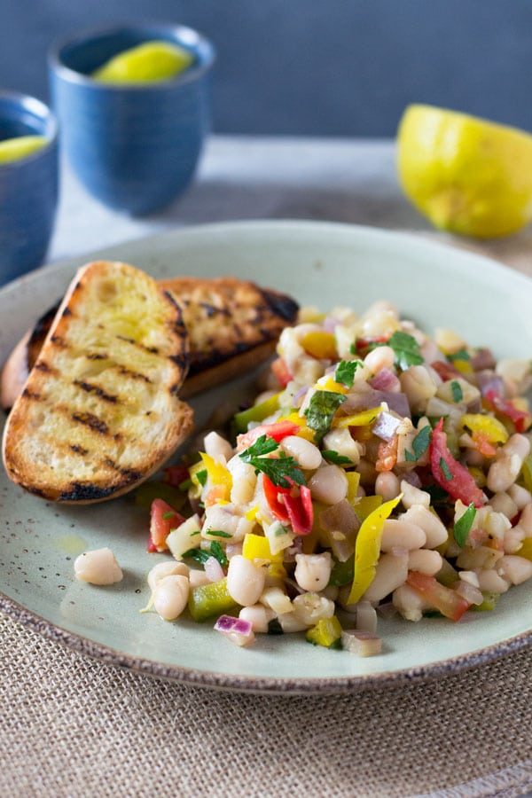 Warm easy bean salad with eggplant, tomato, garlic and fresh herbs.