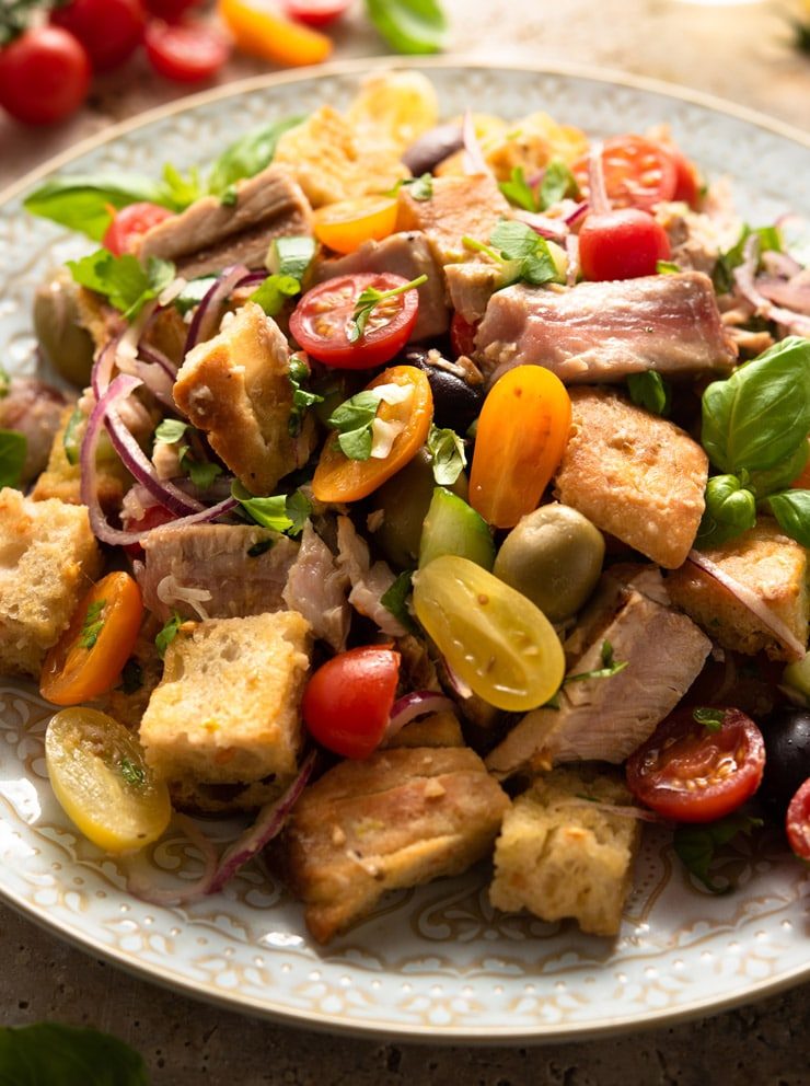 A close up of a tuna panzanella salad on a large serving plate