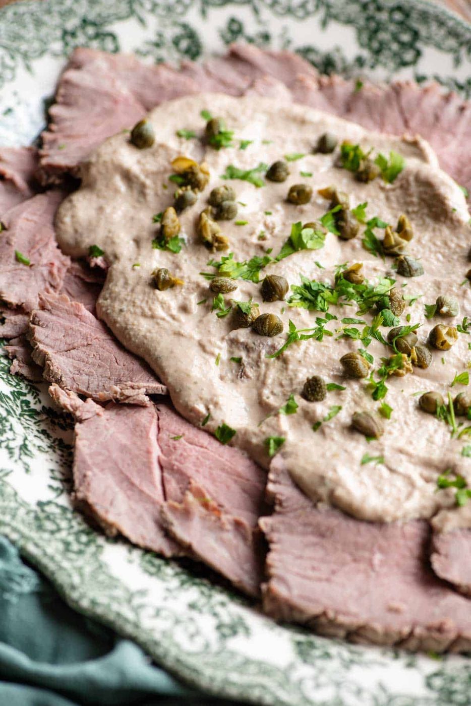 A close up of Vitello Tonnato on a serving dish.