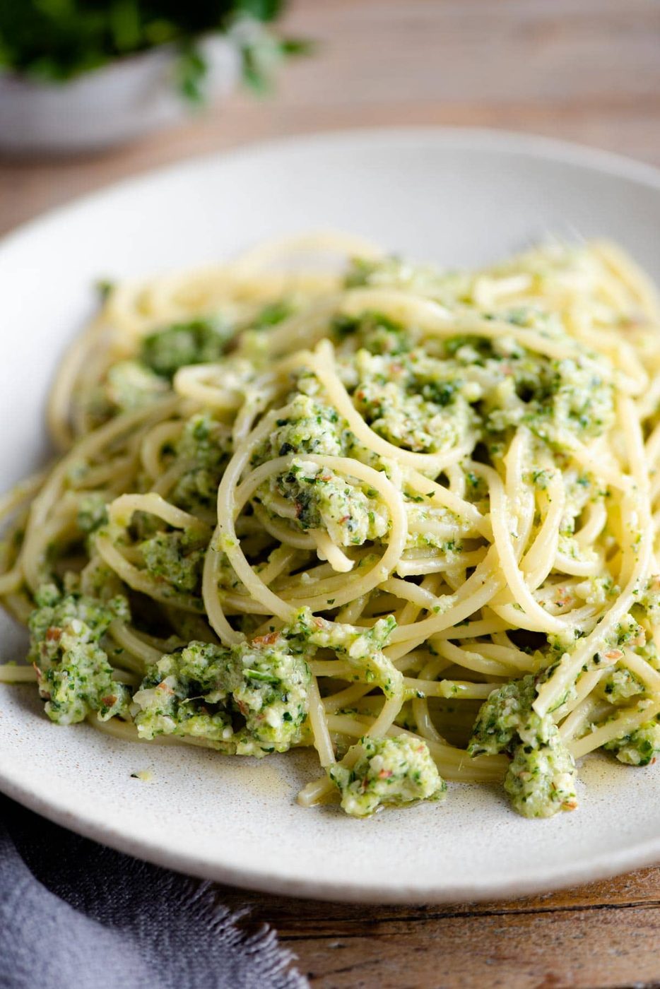 A close up of spaghetti with zucchini pesto on a plate