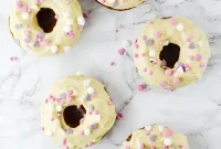 Spiced Carrot Cake Doughnuts with Maple Frosting