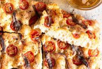 Coastal Focaccia with Bursting Cherry Tomatoes, Salty Anchovies, and Aromatic Oregano