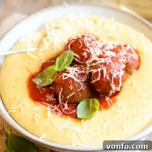 A close up of eggplant meatballs on top of polenta, showcasing a delicious vegetarian Italian meal.