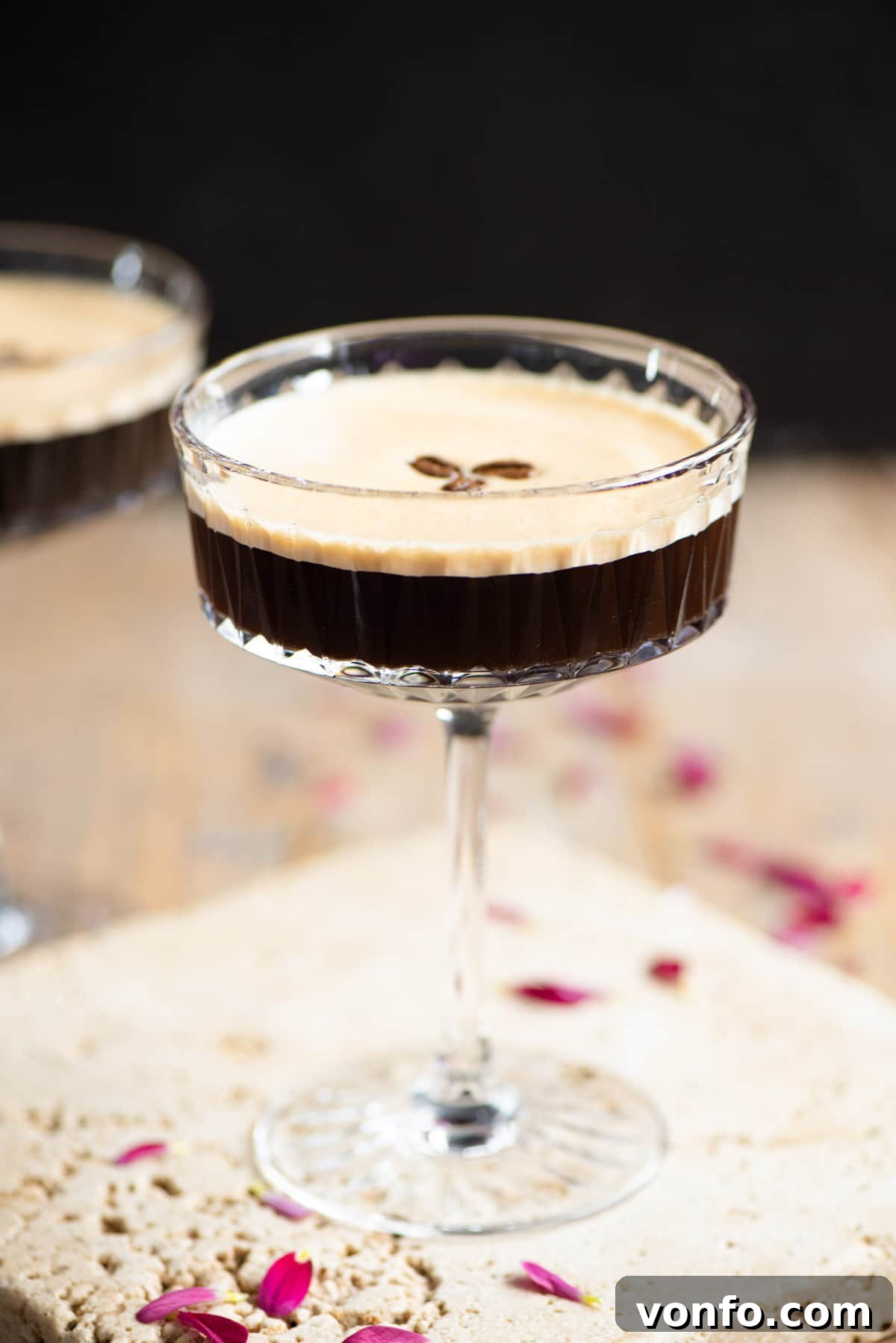 Coffee Cocktail Kick 6 A close-up view of a perfectly mixed Espresso Martini, served in an elegant cocktail glass and garnished with three whole coffee beans, highlighting its rich color and inviting frothy top.