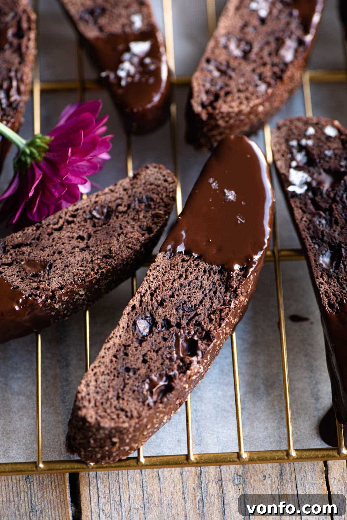 Decadent Triple Chocolate Biscotti 4 A close up of individual chocolate biscotti dipped in melted chocolate, showing the rich texture and detail.
