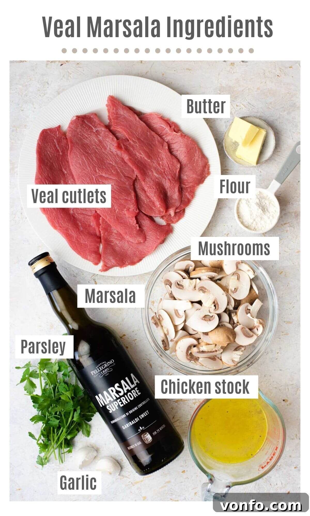 An overhead shot of all the fresh ingredients you need to make homemade Veal Marsala, including veal cutlets, mushrooms, garlic, and Marsala wine.