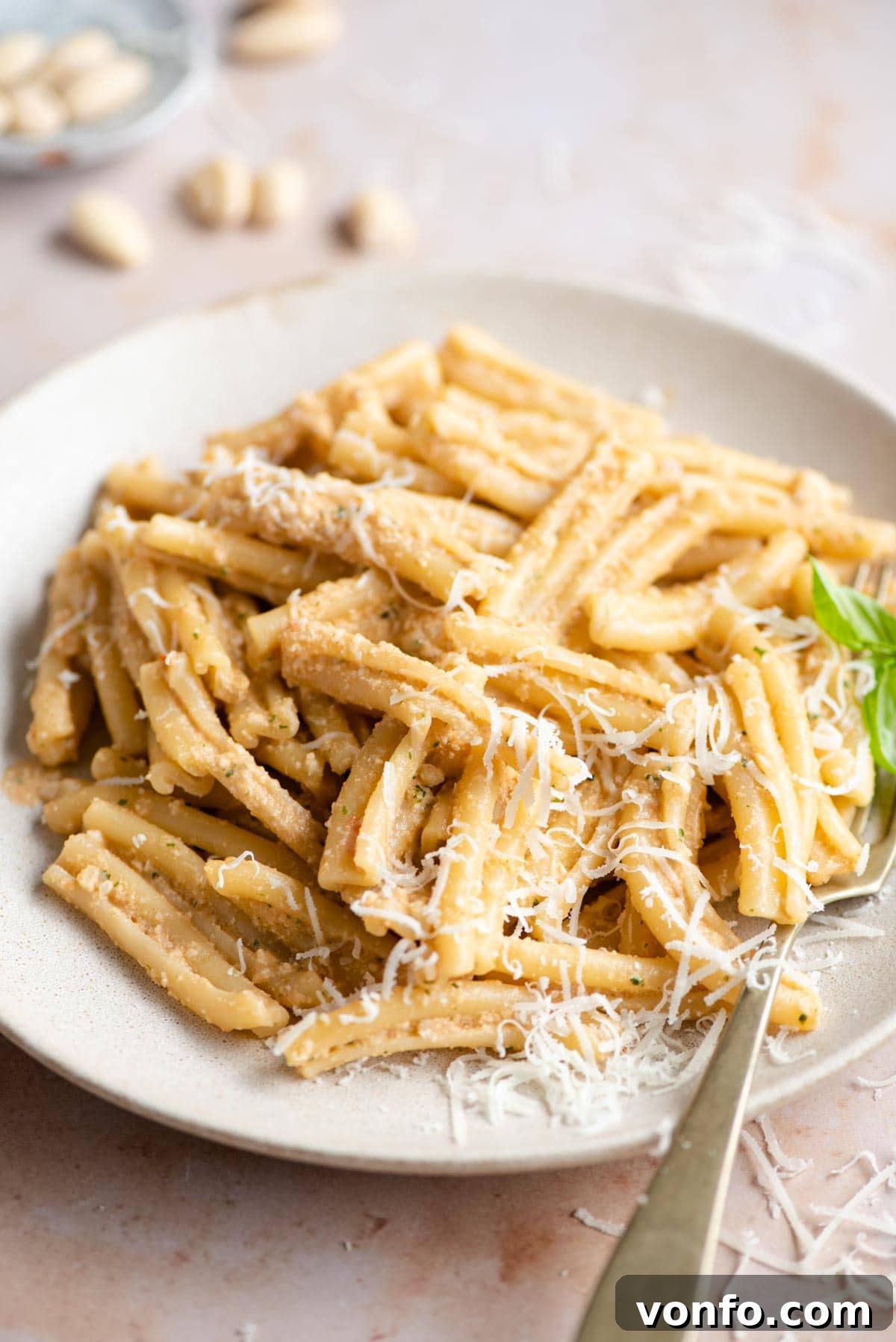 A close up of pesto alla trapanese mixed with pasta, showcasing its rich texture