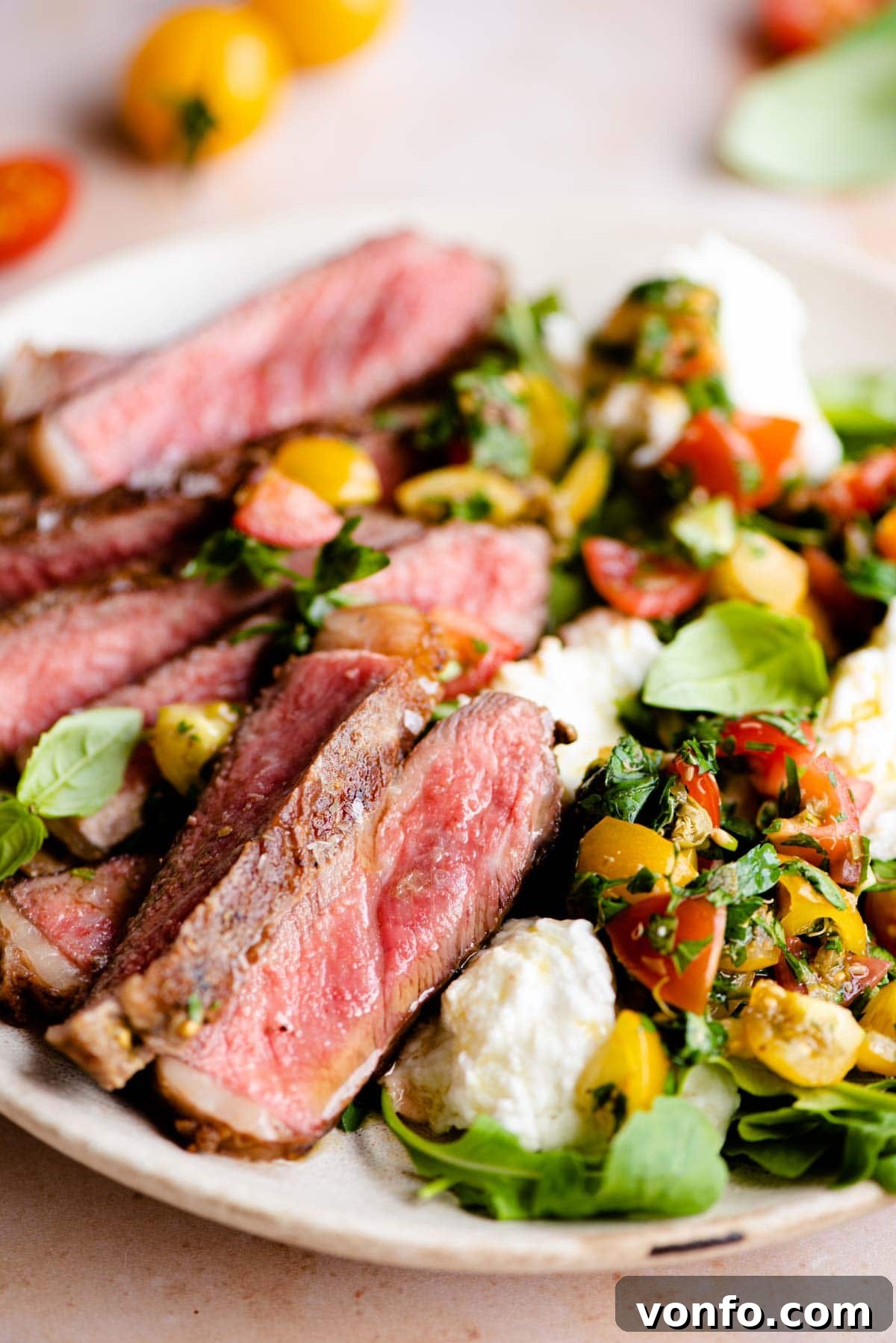 Tuscan Tagliata with Garden Caprese 6 A close-up shot of the finished steak tagliata with its fresh tomato and mozzarella salad