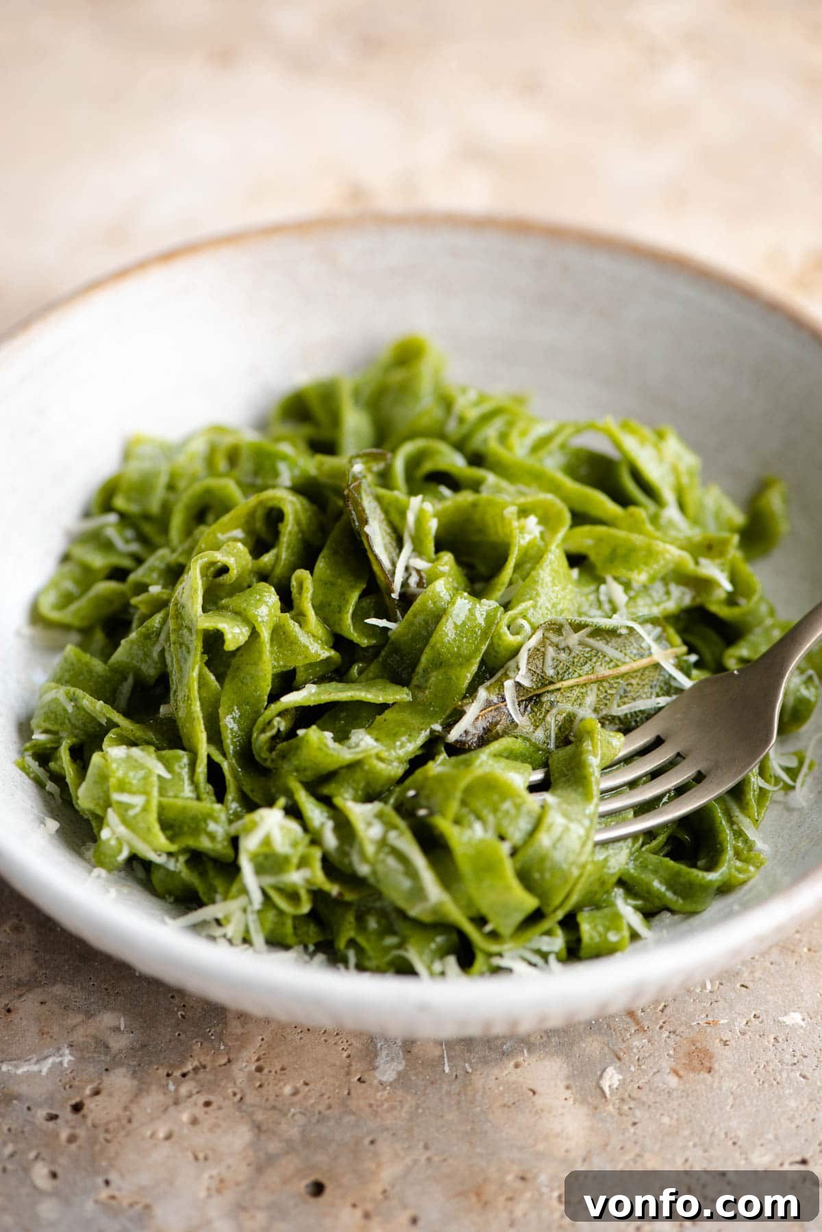 Easy Two-Ingredient Spinach Pasta Dough 9 A close-up shot of cooked green spinach pasta served in a bowl, ready to be sauced.