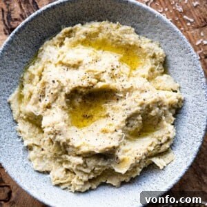 A close up square image of artichoke pesto in a bowl.