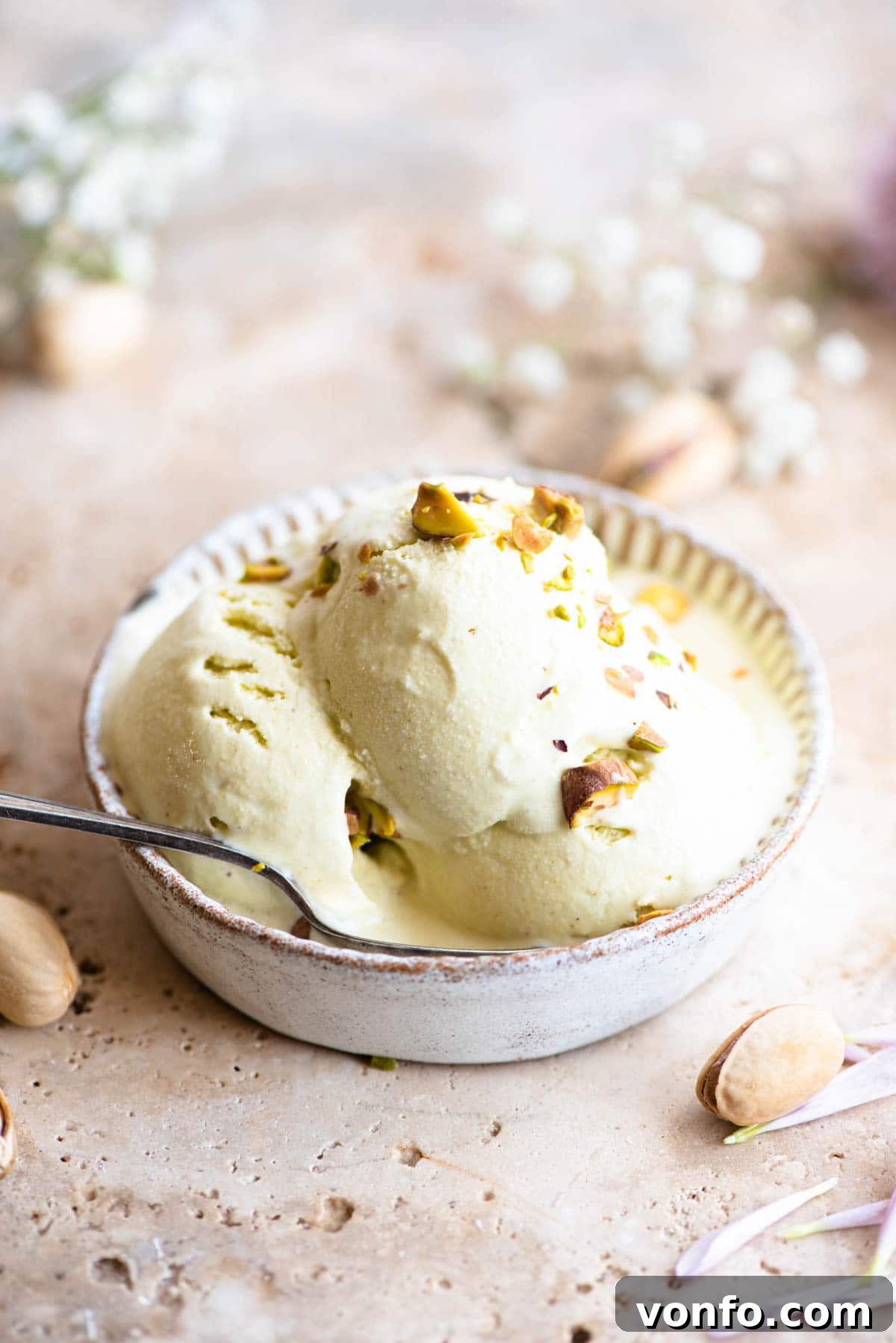 Velvet Pistachio Gelato 2 Three scoops of vibrant green pistachio ice cream in a rustic ramekin, ready to be enjoyed