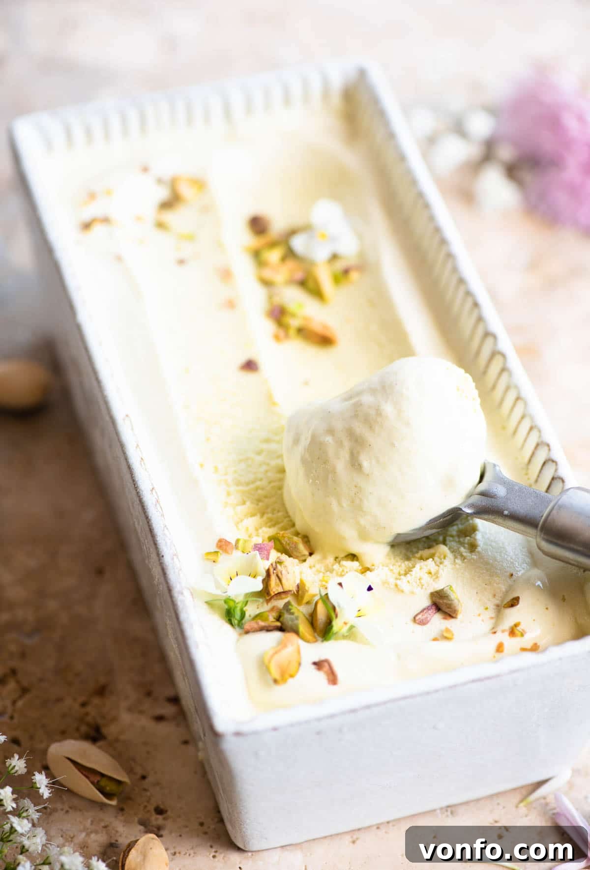 Velvet Pistachio Gelato 6 Pistachio ice cream artfully presented in a loaf dish, with a perfectly scooped portion at one end.