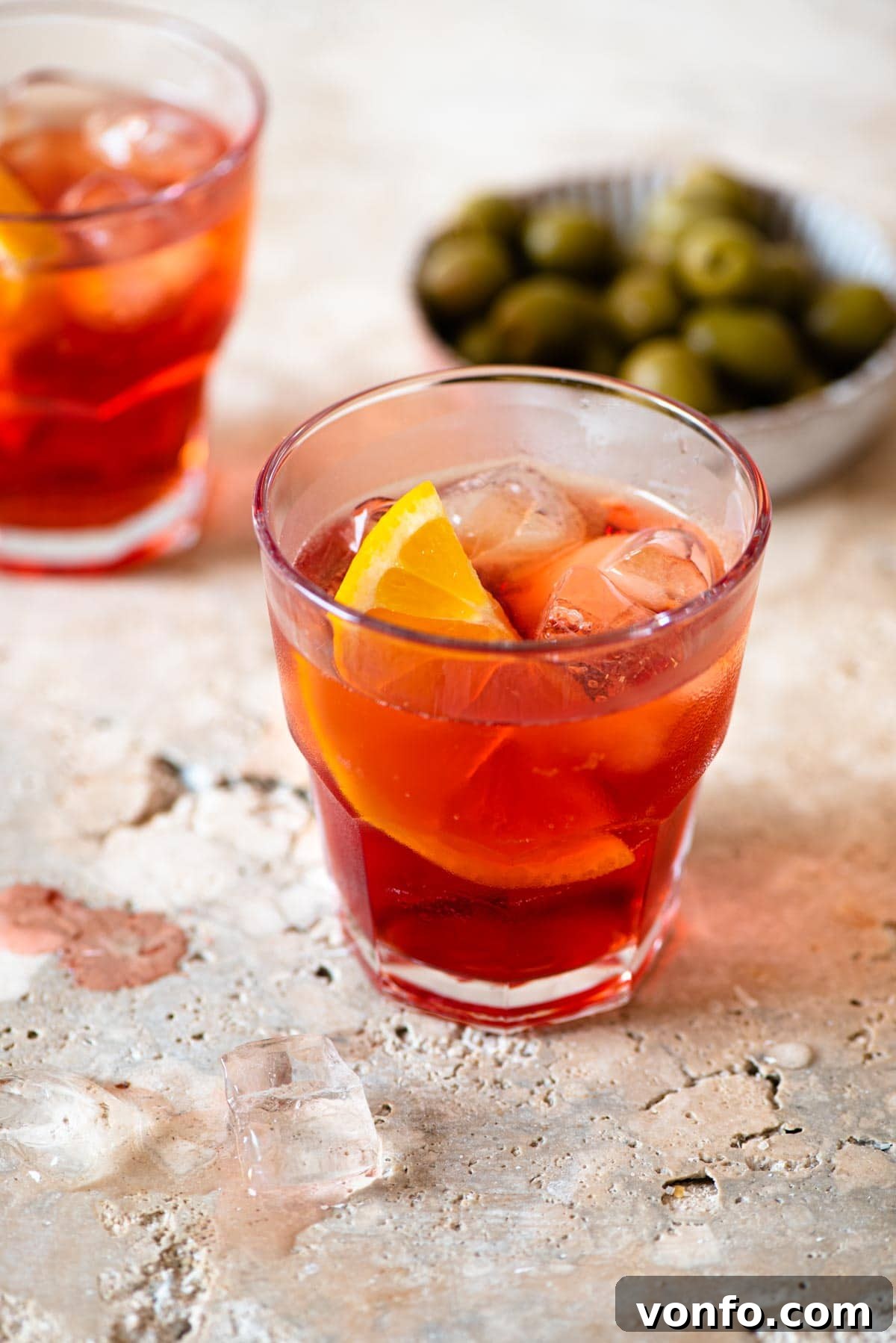 The Original Aperitivo 2 An Americano cocktail on a marble work surface with olives in the background