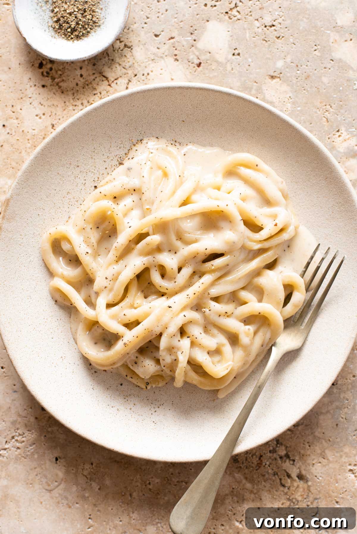 Pici Cacio e Pepe Simple Roman Perfection 2 An overhead shot of pici pasta with cacio e pepe sauce on a plate