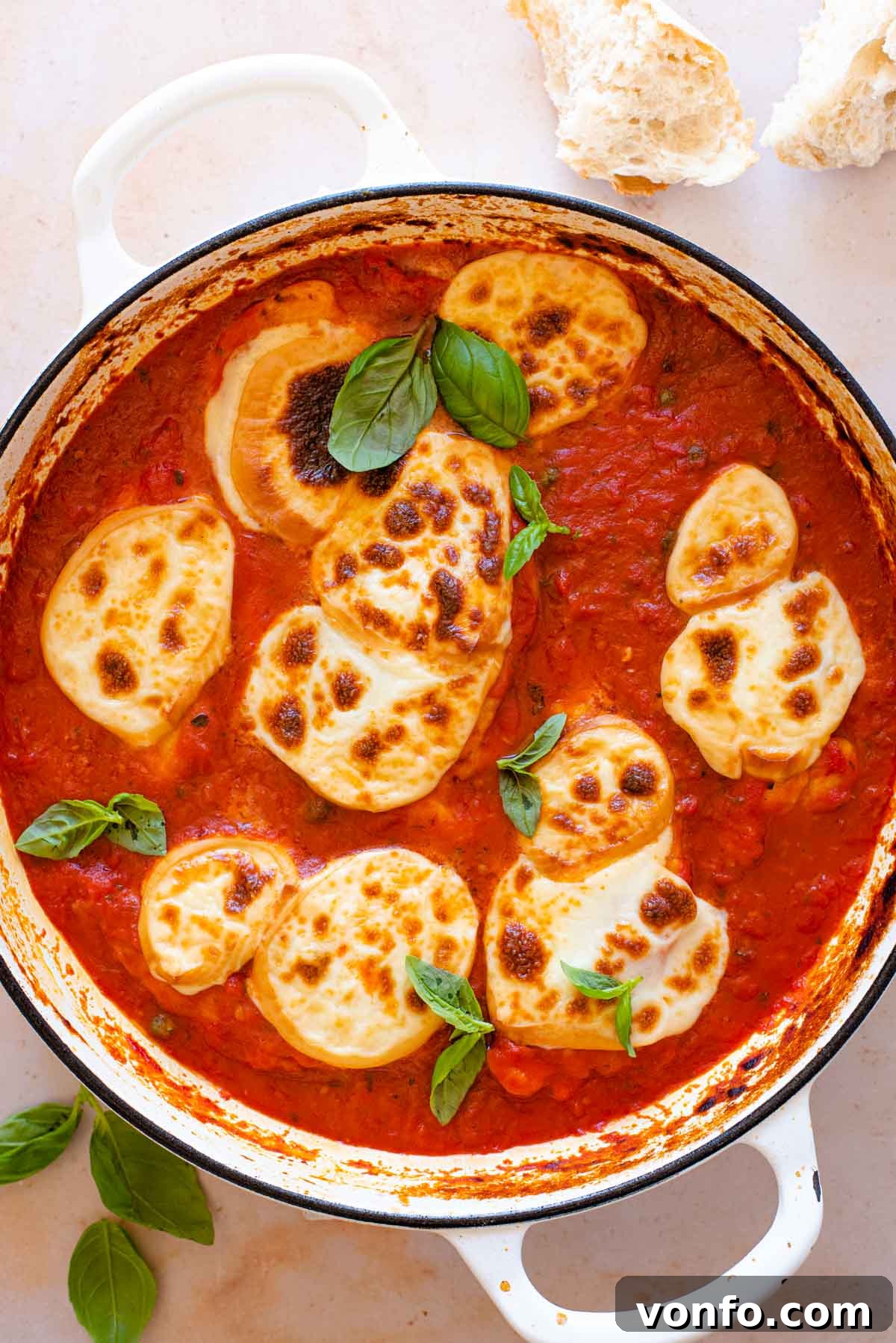 Smoked Scamorza Chicken Pizzaiola 8 An overhead shot of a chicken pizzaiola in a large pan topped with fresh basil