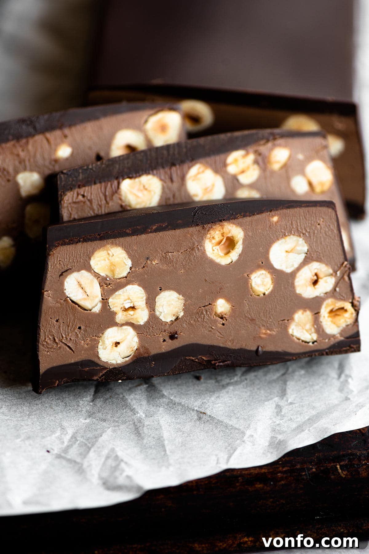 A close-up view of beautifully cut slices of chocolate hazelnut torrone, revealing the creamy filling and crunchy hazelnuts.
