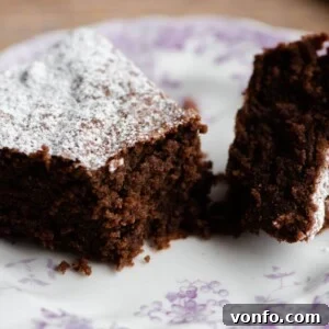 A slice of Torta Caprese cake on a plate, showing its rich, dense interior.