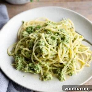 A close up of zucchini pesto pasta on a plate, ready to be enjoyed.