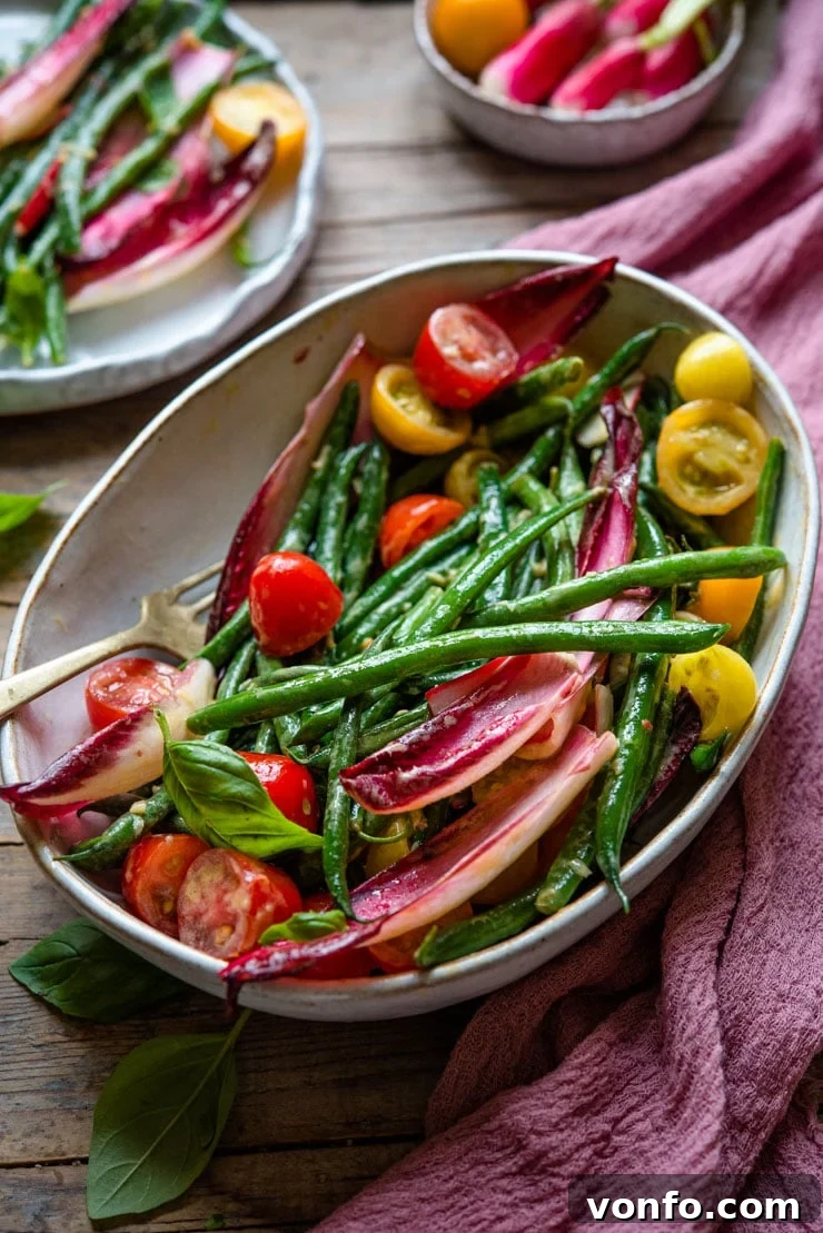Vibrant Green Bean Salad Side Dish A beautiful side shot of a large, rustic serving bowl filled with a fresh green bean salad, highlighting its vibrant ingredients.