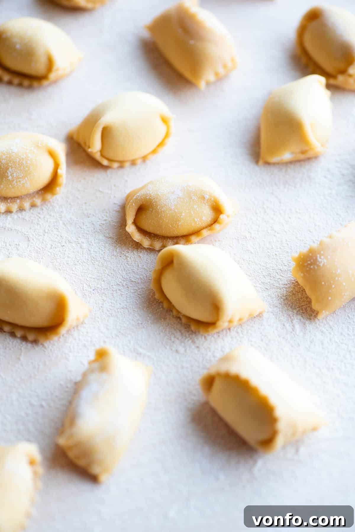 A close up side shot of homemade Agnolotti on a wooden board, showcasing its elegant form.